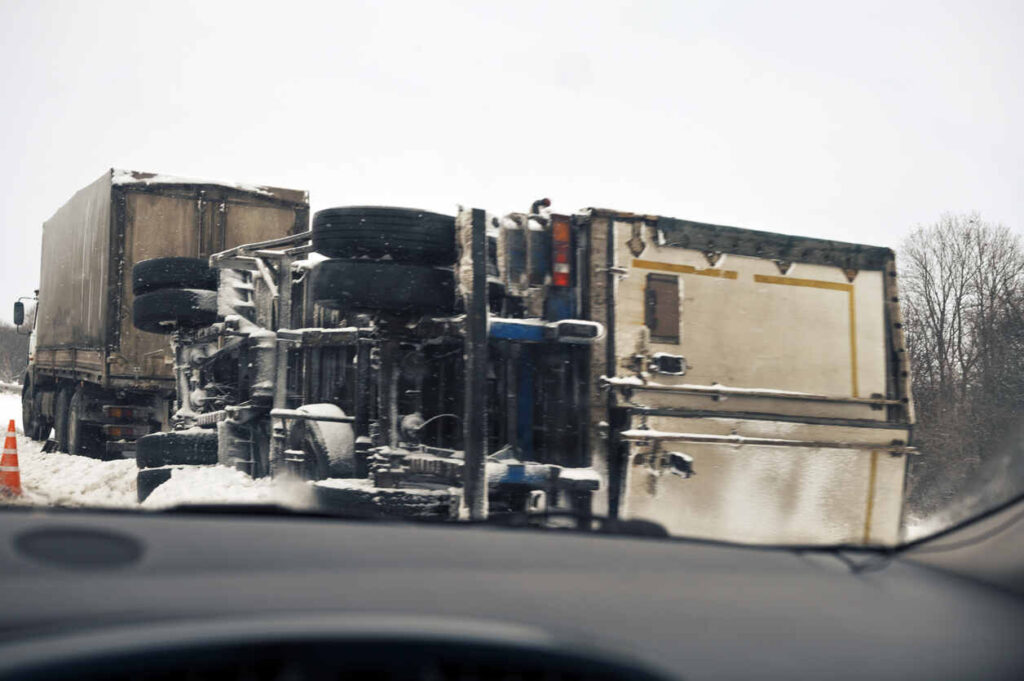 Tipped over truck in front of the car view