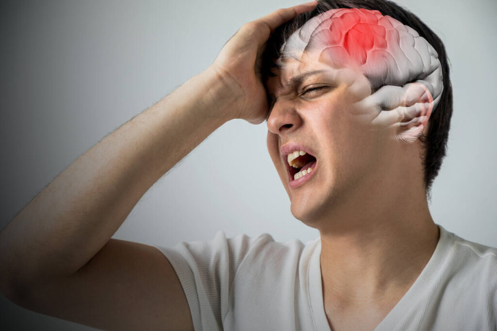 Person experiencing severe head pain with an illustrative overlay showing a brain injury, depicting how a brain injury can affect your life.